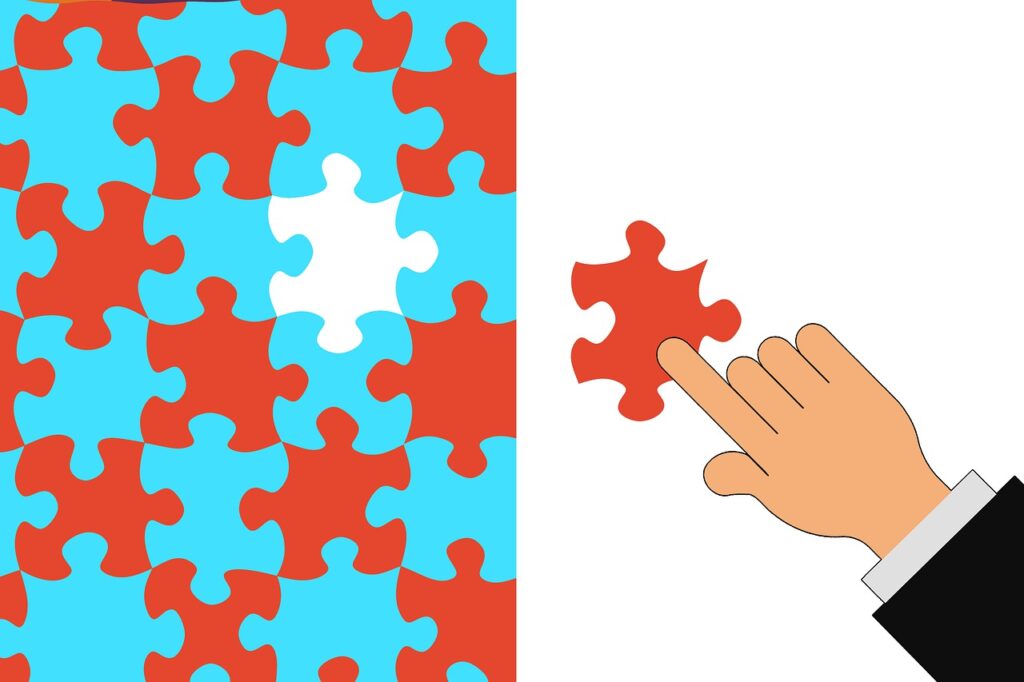 A hand places the last piece into a puzzle